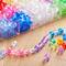 9 Packs: 610 ct. (5,490 total) Multicolor Faceted Plastic Beads by Creatology™, 9mm x 9.5mm